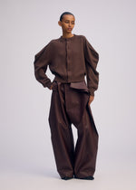 A model wears the ISSEY MIYAKE AKIMBO KNIT clothing.