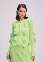 A model wears the ISSEY MIYAKE LINKAGE cardigan.