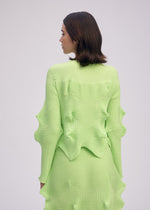 A model wears the ISSEY MIYAKE LINKAGE cardigan.