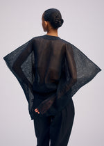 A model wears the ISSEY MIYAKE CIALDA cardigan.