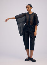 A model wears the ISSEY MIYAKE CIALDA cardigan.