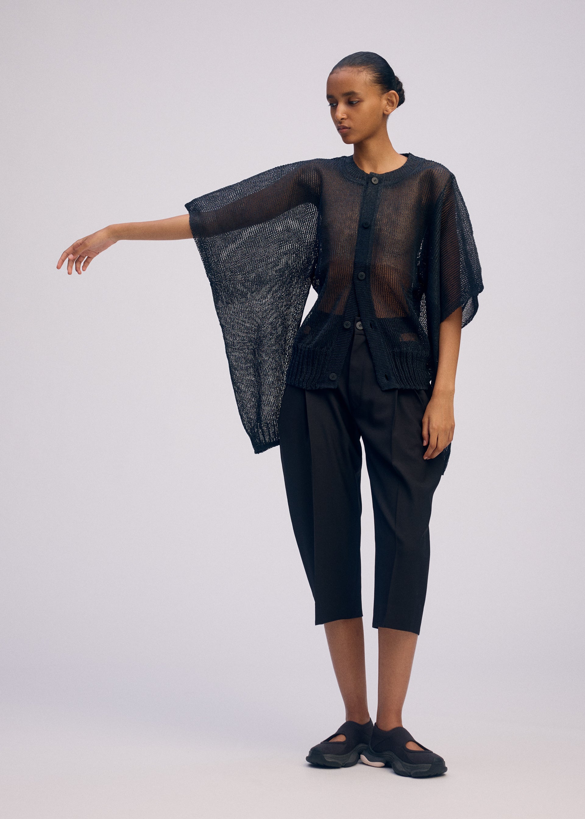 A model wears the ISSEY MIYAKE CIALDA cardigan.