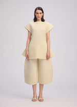 A model wears the ISSEY MIYAKE CORRUGATED KNIT dress.