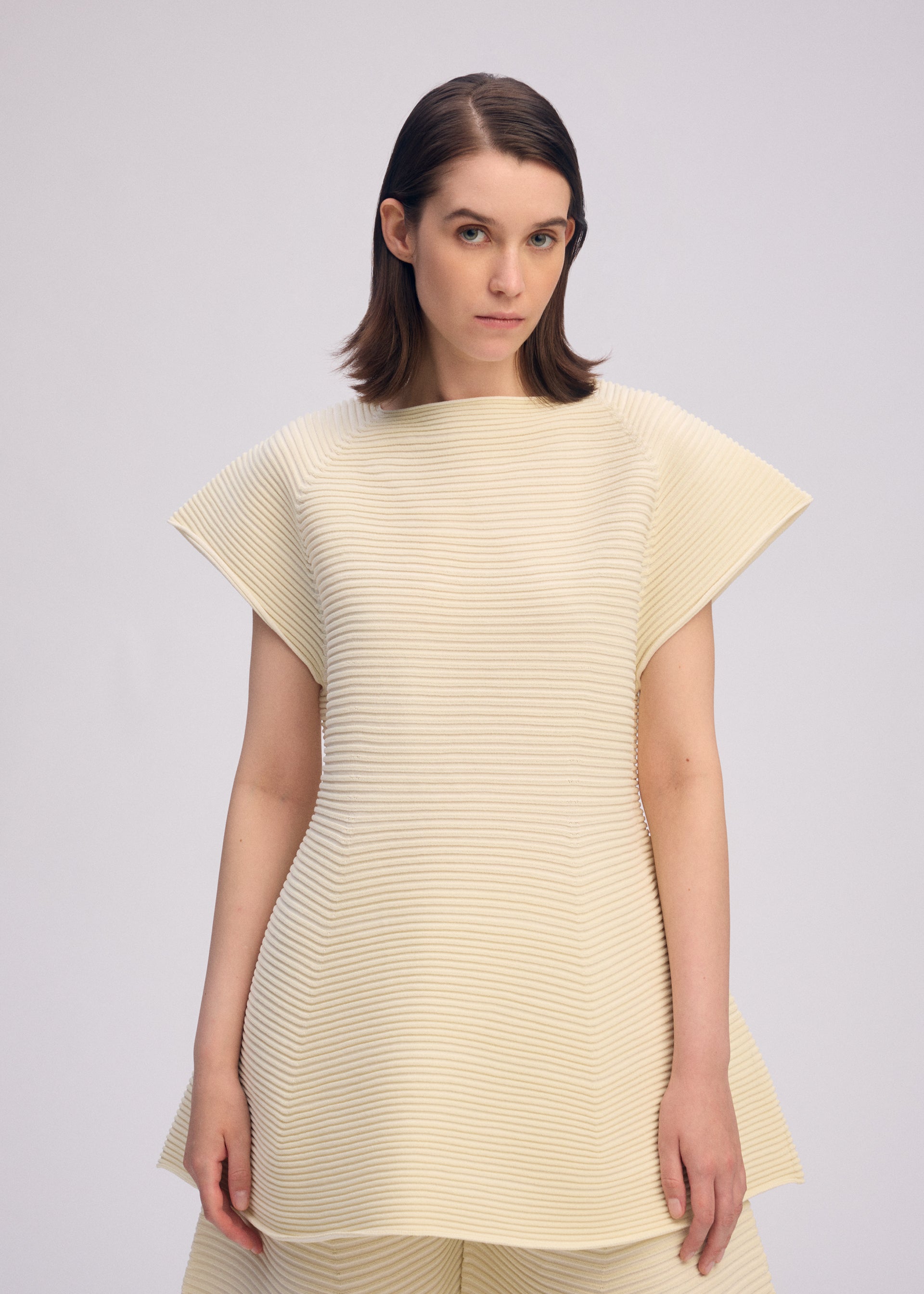 A model wears the ISSEY MIYAKE CORRUGATED KNIT dress.
