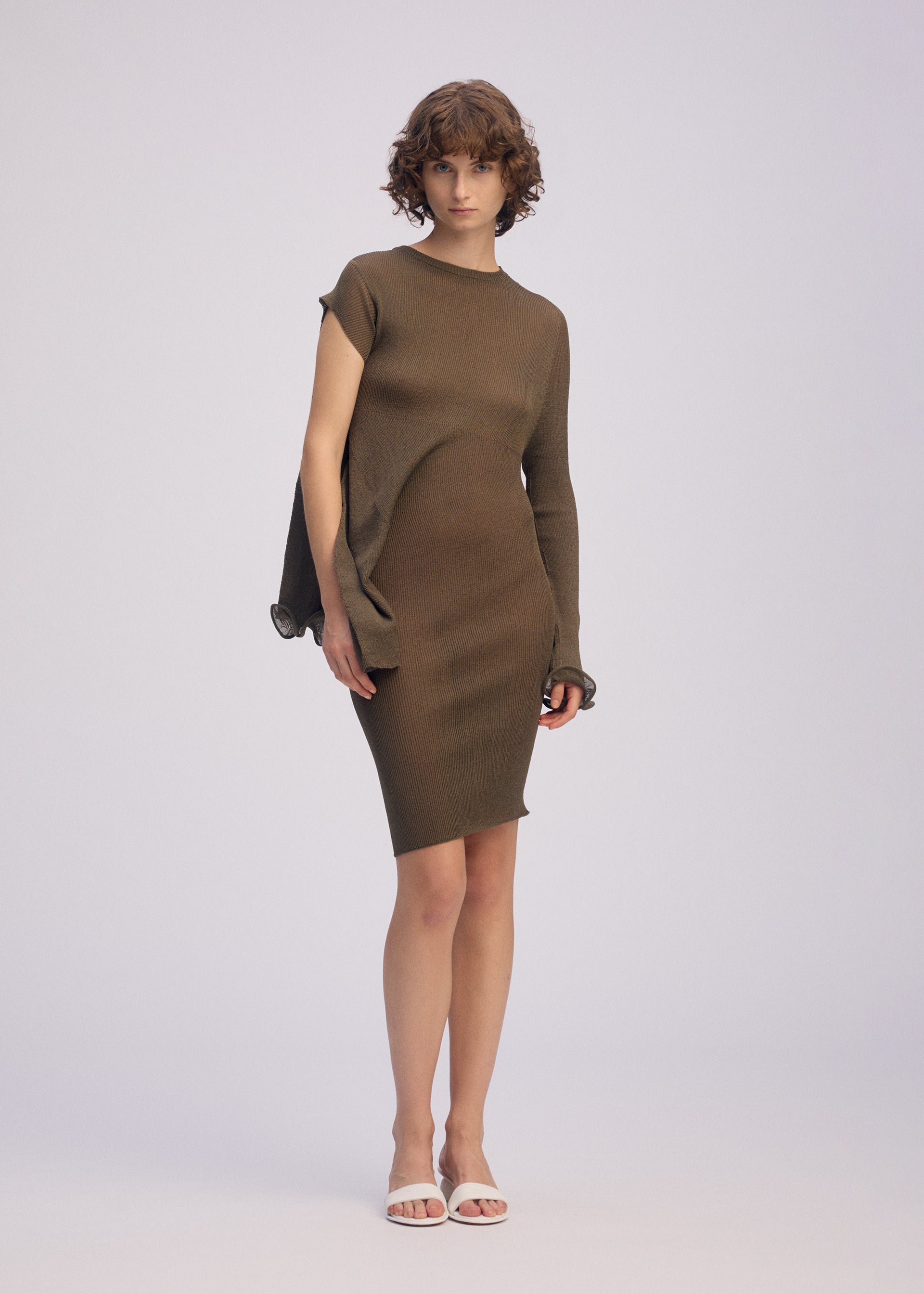 A model wears the ISSEY MIYAKE ADVENTITIOUS SLEEVES dress.