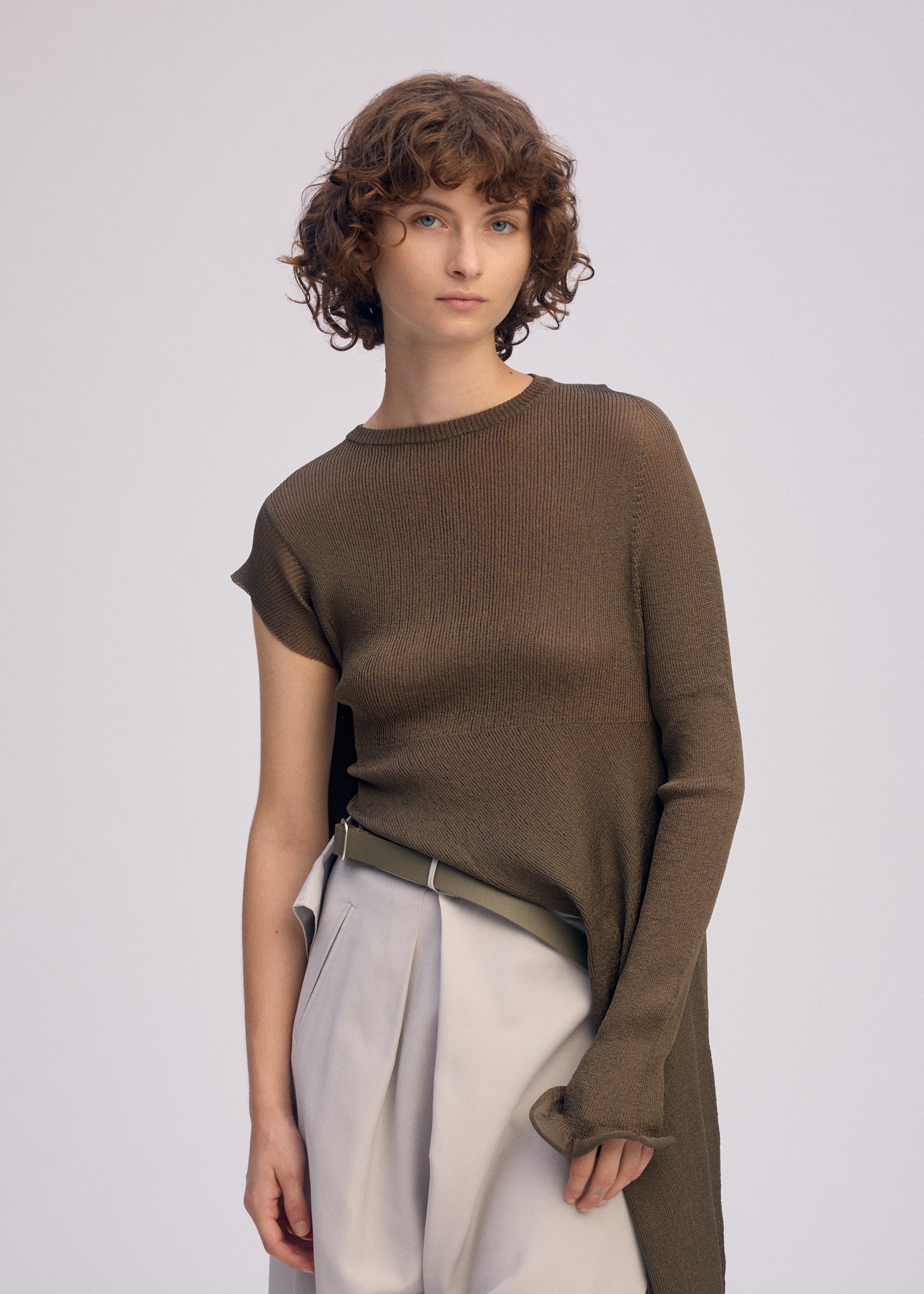 A model wears the ISSEY MIYAKE ADVENTITIOUS SLEEVES dress.