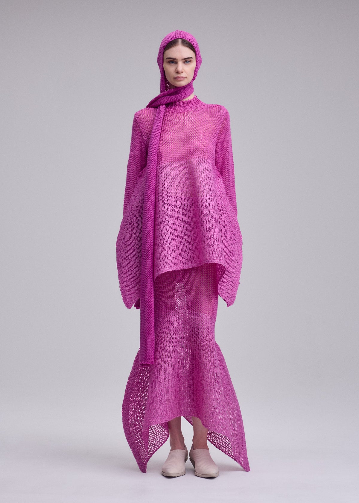 A model wears the ISSEY MIYAKE PANINI BALACLAVA panini-balaclava-cap-black.