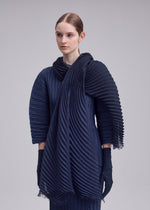 A model wears the ISSEY MIYAKE GRADATION RAMIE PLEATS STOLE gradation-ramie-pleats-stole-stole-white-hued.