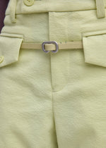 A model wears the ISSEY MIYAKE SOLID LEATHER BELT belt.