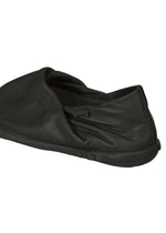 A detail shot of the ISSEY MIYAKE PEU FORM shoes.