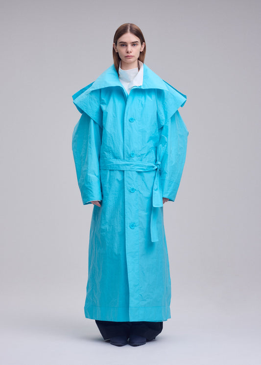 A model wears the ISSEY MIYAKE CORRELATION correlation-coat-dark-navy.