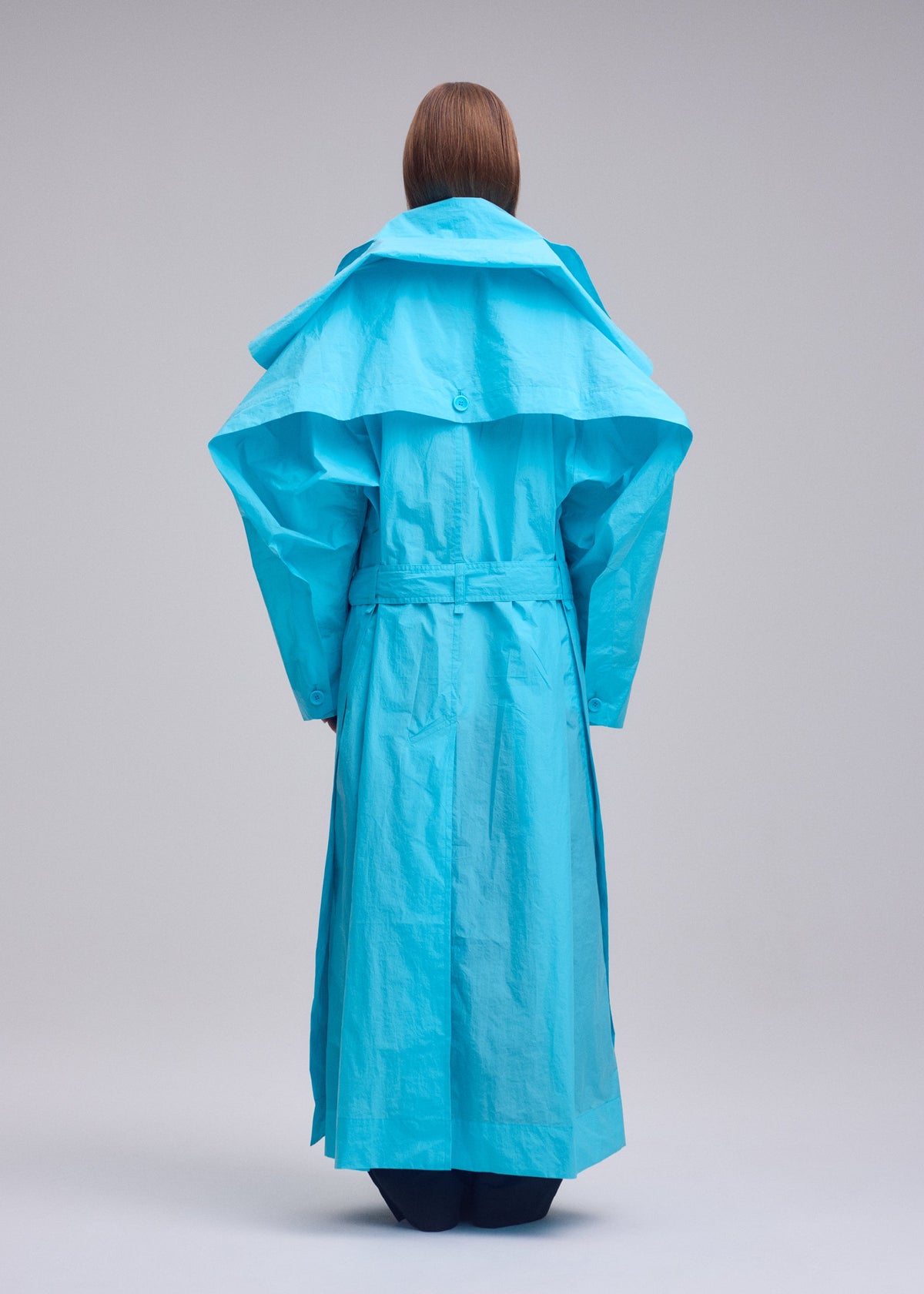 A model wears the ISSEY MIYAKE CORRELATION correlation-coat-dark-navy.