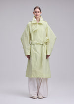A model wears the ISSEY MIYAKE CORRELATION correlation-dynamic-silhouette-coat-dark-navy.