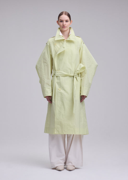 A model wears the ISSEY MIYAKE CORRELATION correlation-dynamic-silhouette-coat-dark-navy.