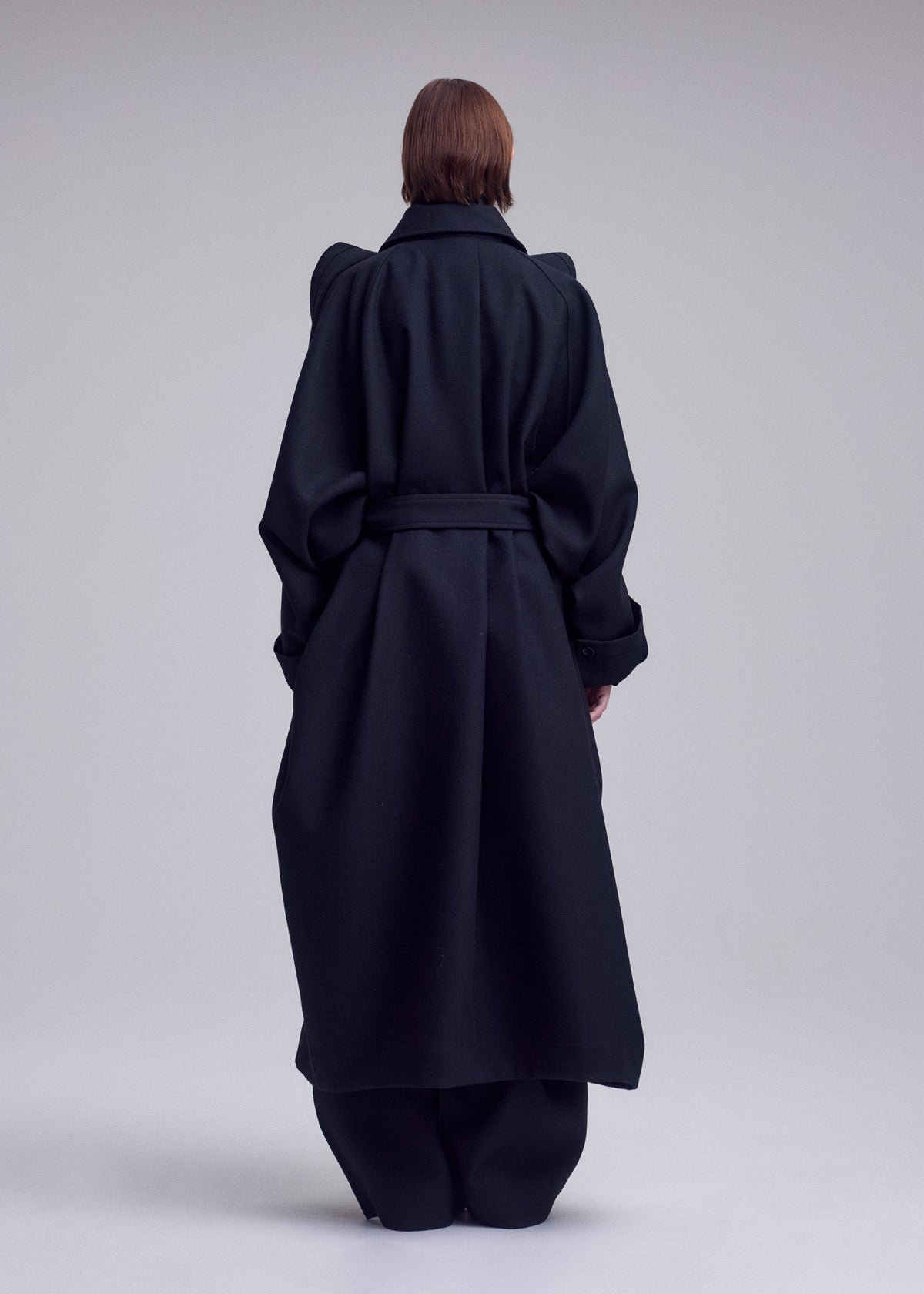 A model wears the ISSEY MIYAKE CALLIGRAPH calligraph-coat-purple.