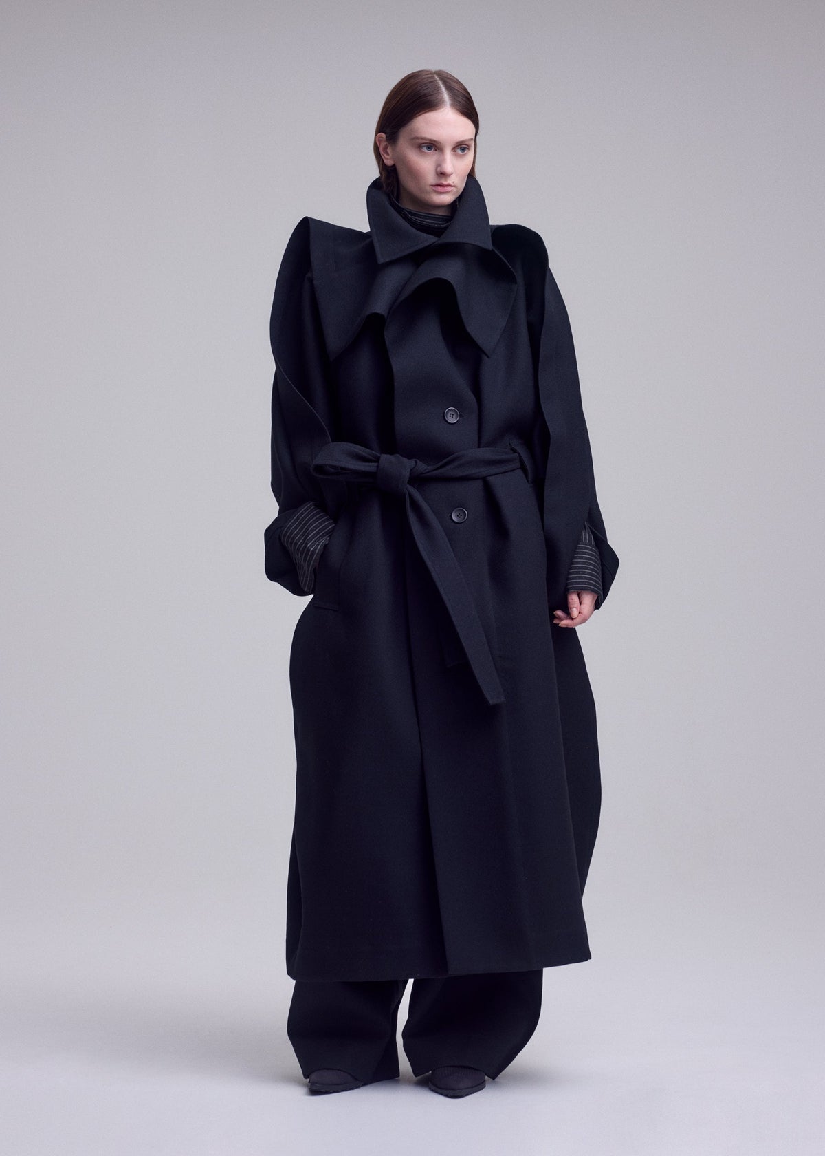 A model wears the ISSEY MIYAKE CALLIGRAPH calligraph-coat-purple.