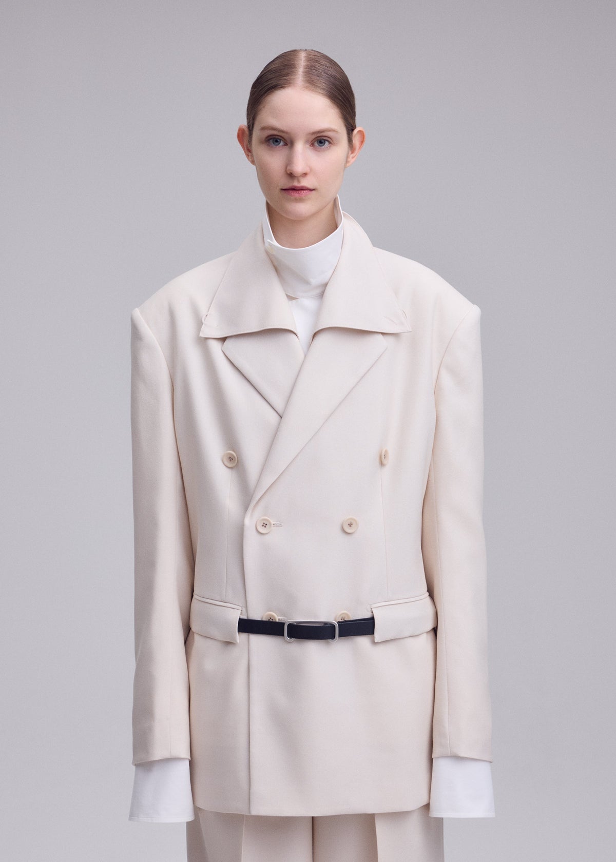 A model wears the ISSEY MIYAKE UNTITLED untitled-jacket-brown.