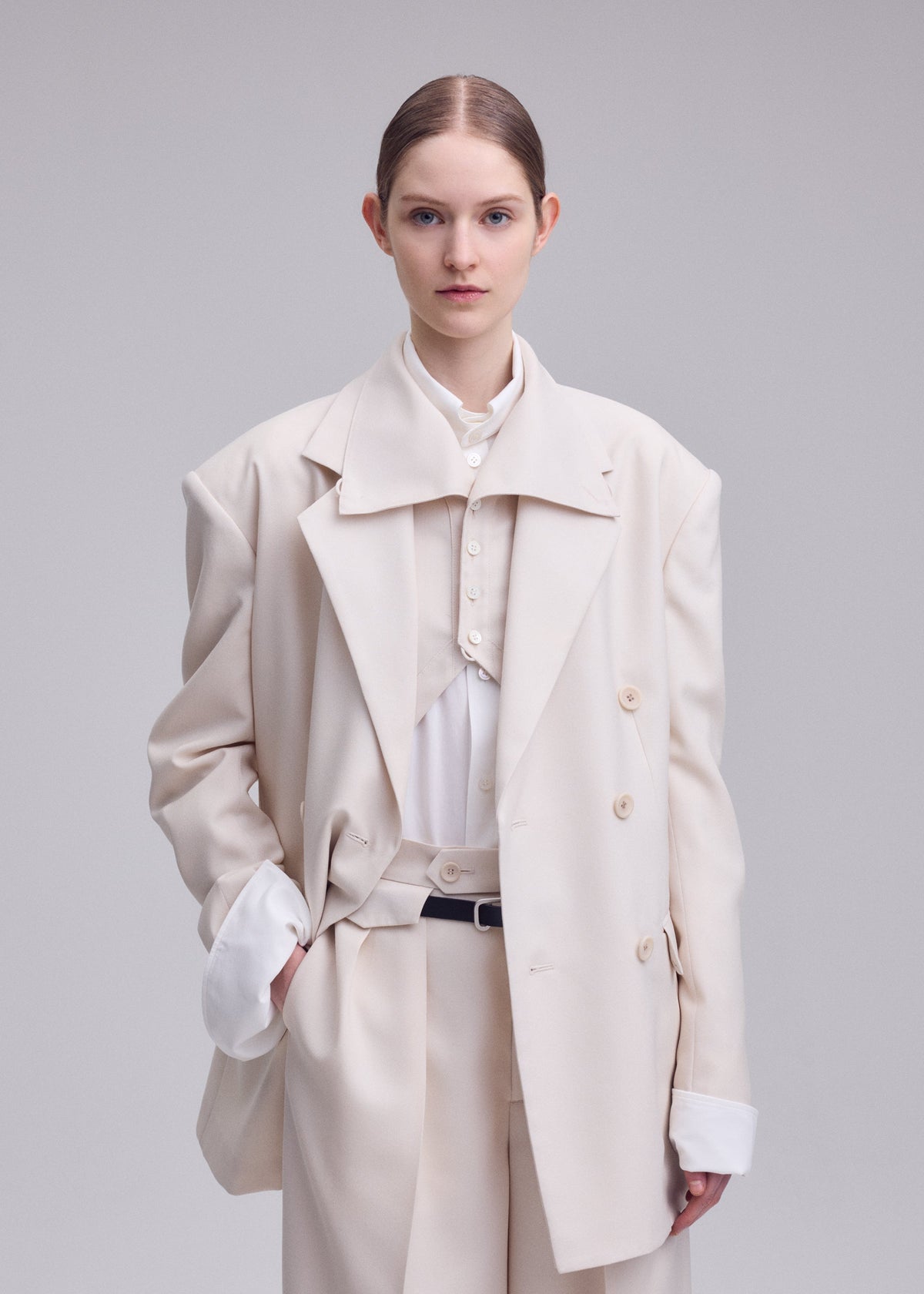 A model wears the ISSEY MIYAKE UNTITLED untitled-jacket-brown.