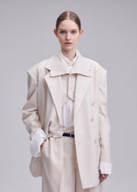 A model wears the ISSEY MIYAKE UNTITLED untitled-jacket-brown.