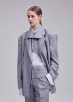 A model wears the ISSEY MIYAKE HONEST ENSEMBLE honest-ensemble-jacket-black.