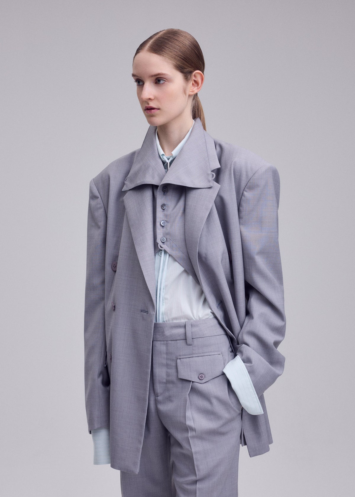 A model wears the ISSEY MIYAKE HONEST ENSEMBLE honest-ensemble-jacket-black.