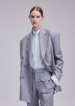A model wears the ISSEY MIYAKE HONEST ENSEMBLE honest-ensemble-jacket-black.