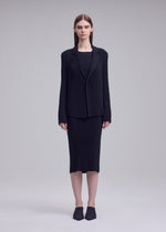 A model wears the ISSEY MIYAKE HATCHING PLEATS hatching-pleats-blazer-style-jacket-black.