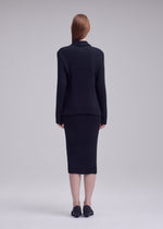 A model wears the ISSEY MIYAKE HATCHING PLEATS hatching-pleats-blazer-style-jacket-grey.
