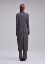 A model wears the ISSEY MIYAKE HATCHING PLEATS hatching-pleats-mid-length-vest-black.