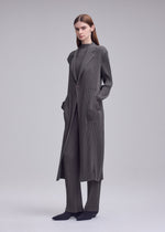 A model wears the ISSEY MIYAKE HATCHING PLEATS hatching-pleats-mid-length-vest-grey.