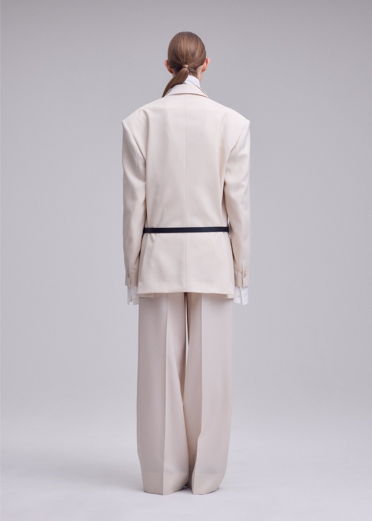 A model wears the ISSEY MIYAKE UNTITLED untitled-trousers-brown.