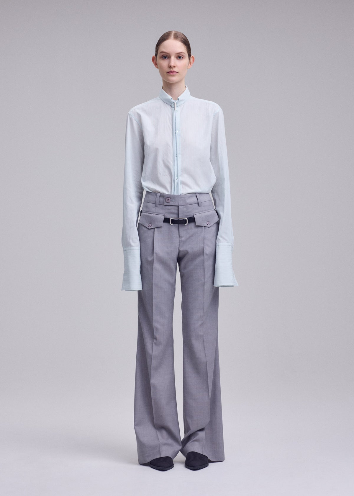 A model wears the ISSEY MIYAKE HONEST ENSEMBLE honest-ensemble-trousers-black.