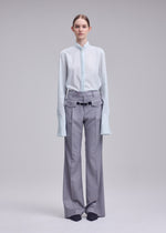 A model wears the ISSEY MIYAKE HONEST ENSEMBLE honest-ensemble-trousers-grey.