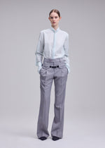 A model wears the ISSEY MIYAKE HONEST ENSEMBLE honest-ensemble-trousers-black.
