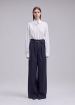 A model wears the ISSEY MIYAKE HONEST ENSEMBLE honest-ensemble-wide-leg-trousers-grey.
