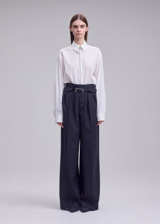 A model wears the ISSEY MIYAKE HONEST ENSEMBLE honest-ensemble-wide-leg-trousers-black.