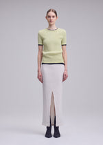 A model wears the ISSEY MIYAKE RILL rill-skirt-green.