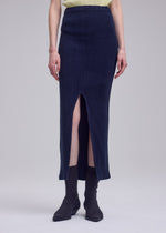 A model wears the ISSEY MIYAKE RILL rill-skirt-off-white.