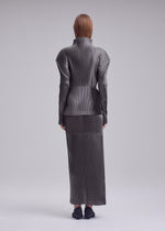 A model wears the ISSEY MIYAKE GLOSSED PANELS PLEATS glossed-panels-pleats-skirt-light-pink.