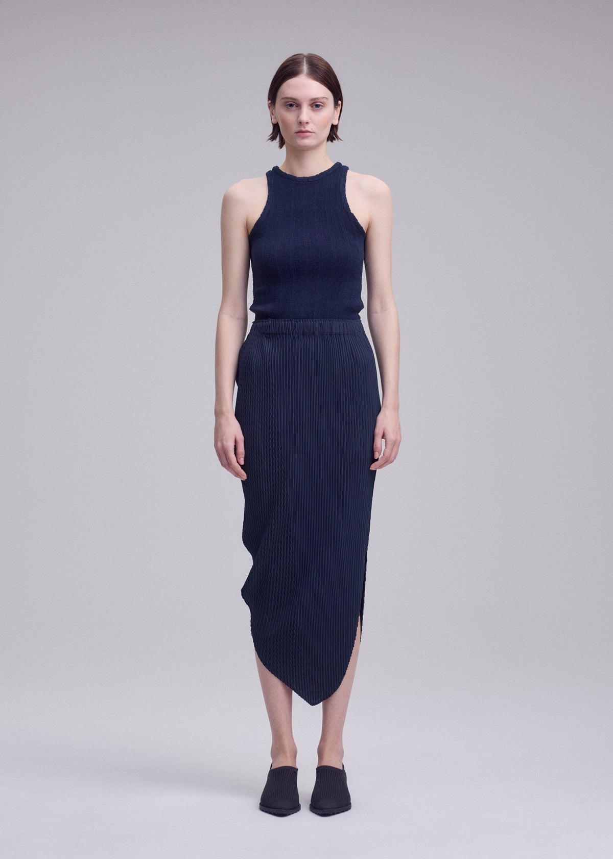 A model wears the ISSEY MIYAKE LEAF PLEATS leaf-pleats-skirt-light-blue.