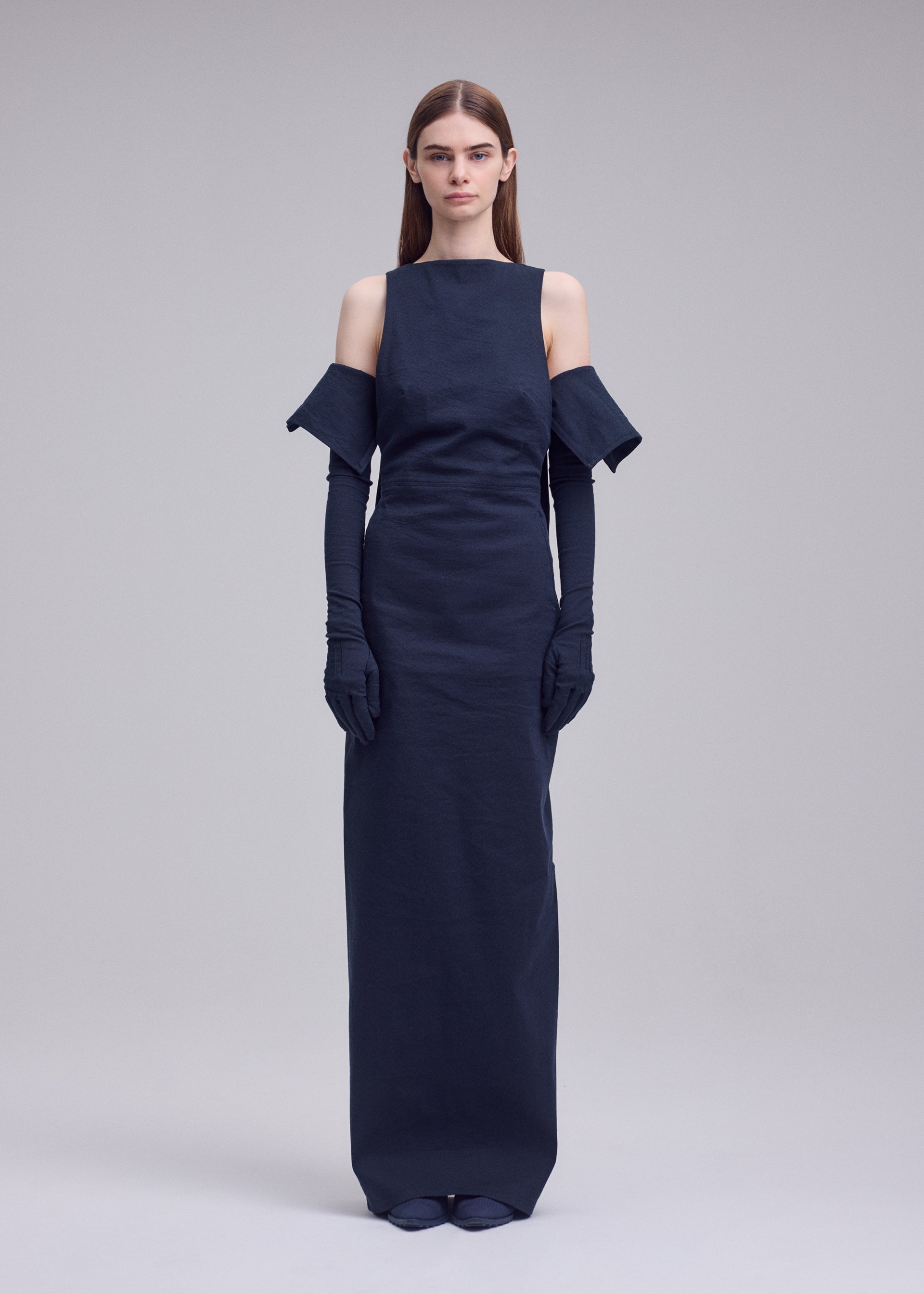 A model wears the ISSEY MIYAKE ALLOW dress.