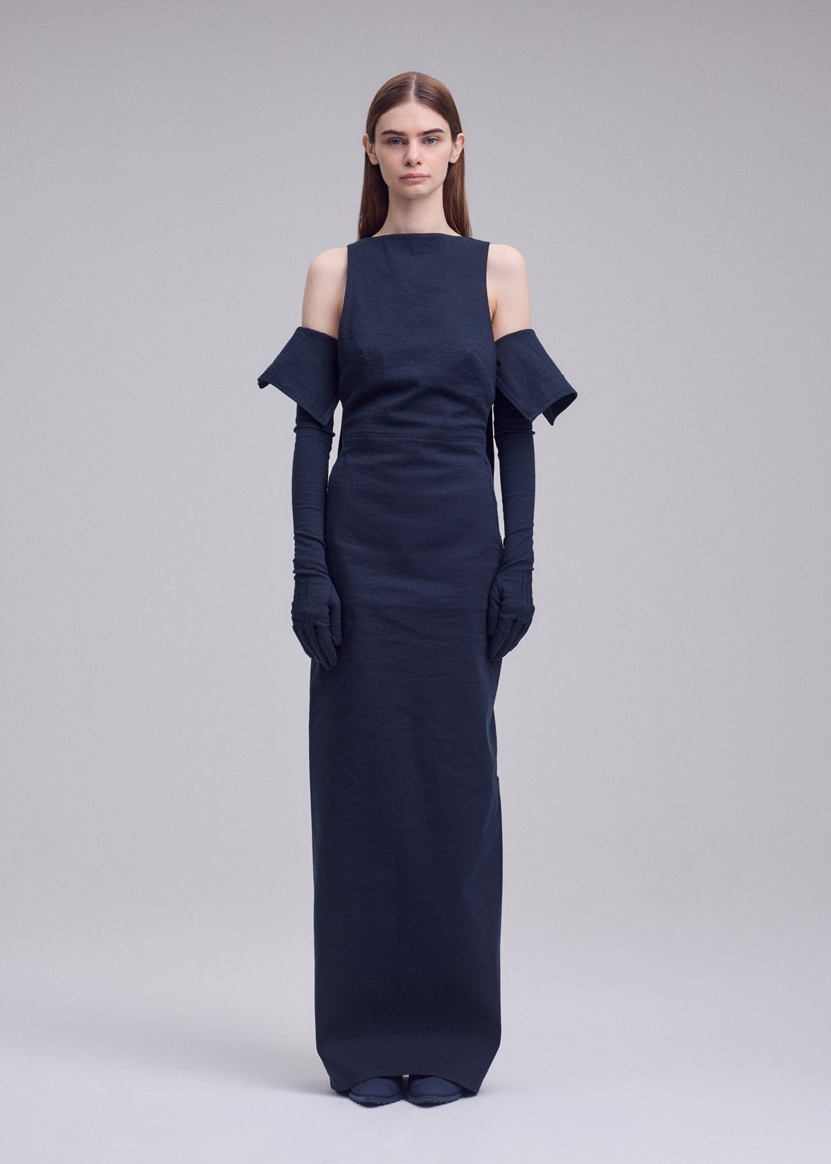 A model wears the ISSEY MIYAKE ALLOW dress.