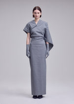 A model wears the ISSEY MIYAKE ALLOW dress.