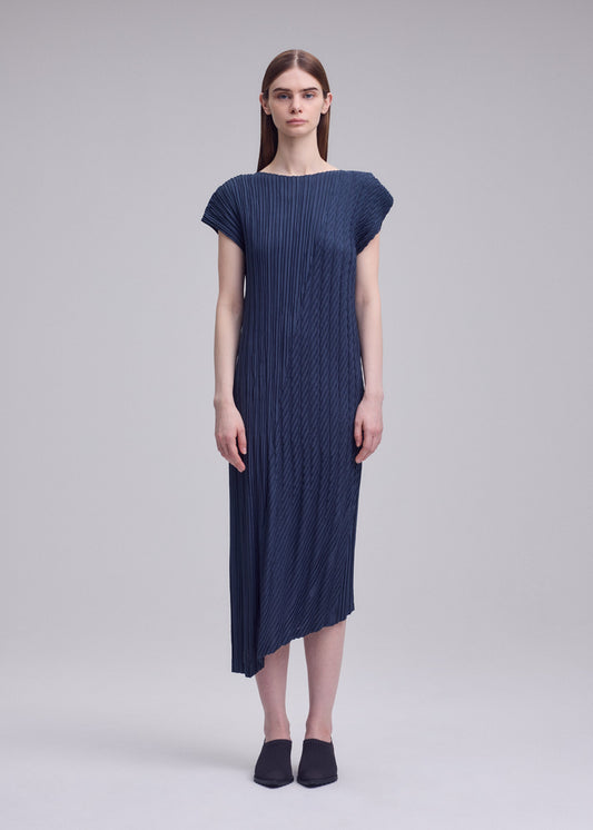A model wears the ISSEY MIYAKE UNFURLING PLEATS dress.