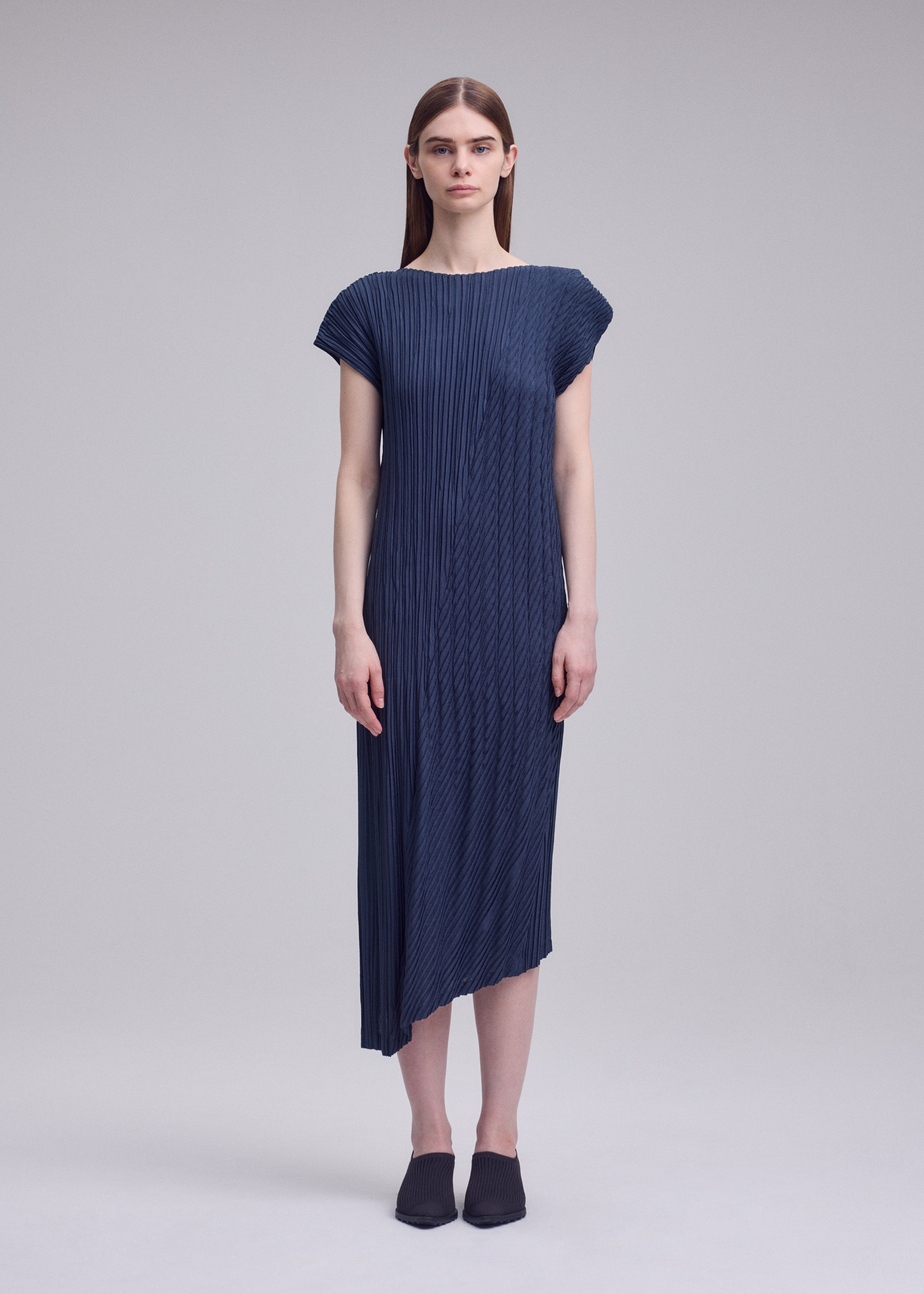 A model wears the ISSEY MIYAKE UNFURLING PLEATS dress.