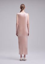 A model wears the ISSEY MIYAKE GLOSSED PANELS PLEATS glossed-panels-pleats-dress-light-pink.