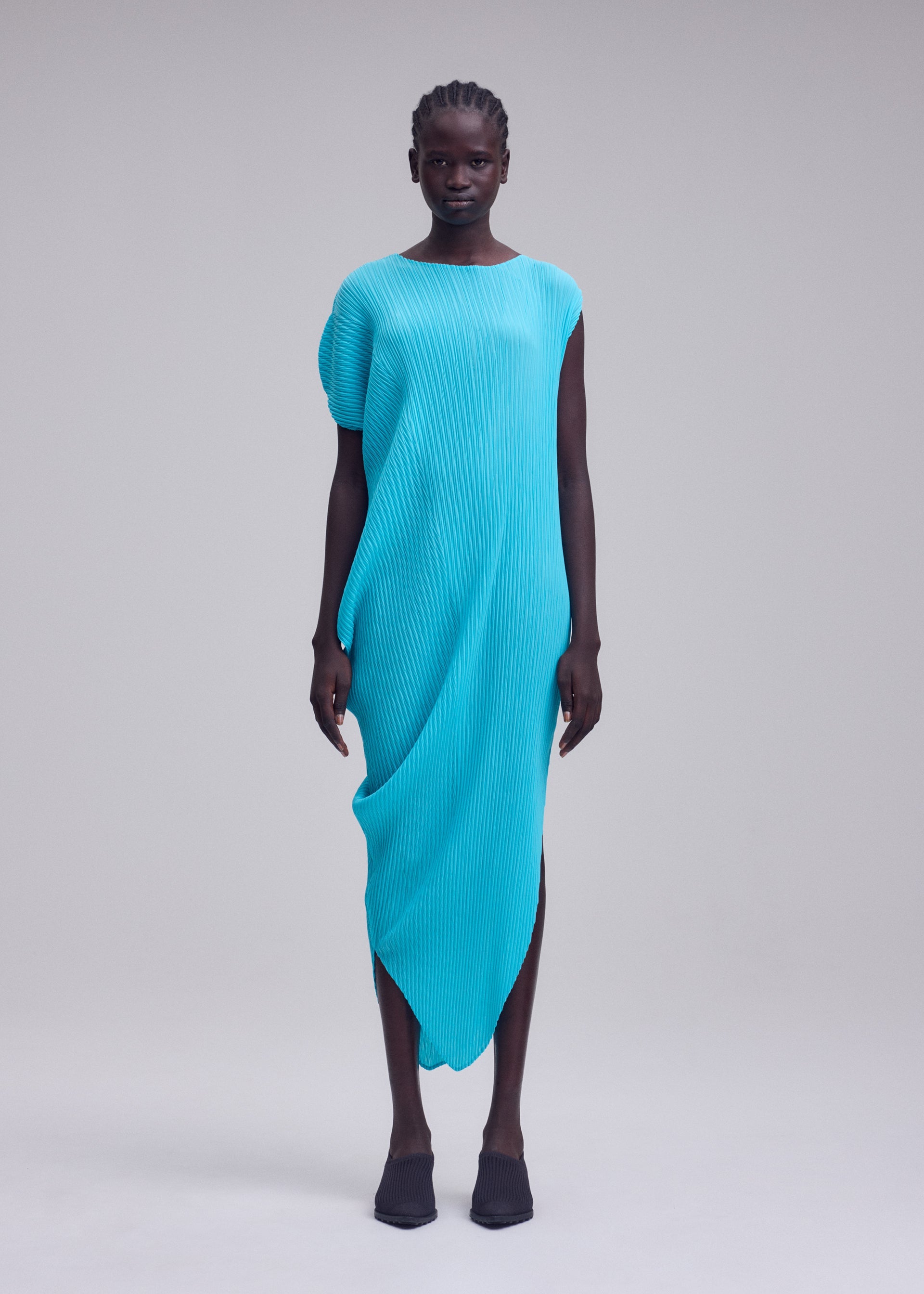A model wears the ISSEY MIYAKE LEAF PLEATS leaf-pleats-dress-off-white.