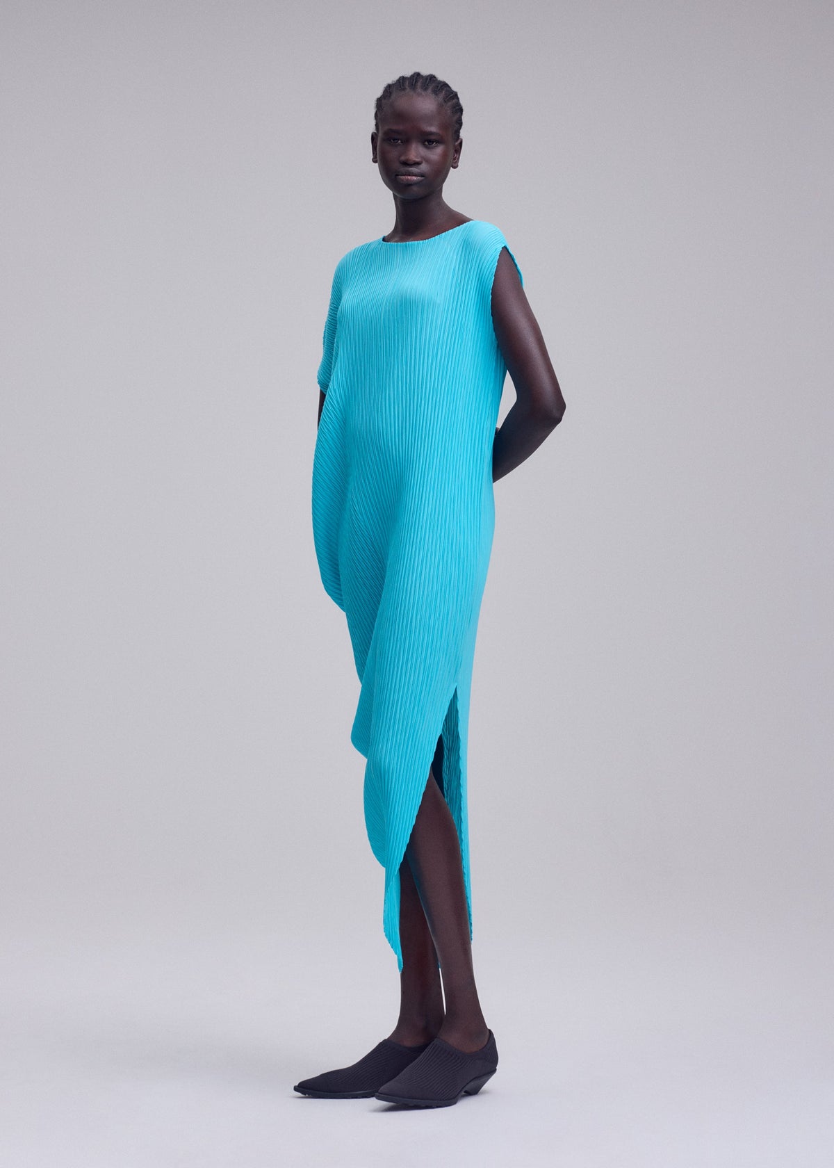 A model wears the ISSEY MIYAKE LEAF PLEATS leaf-pleats-dress-off-white.