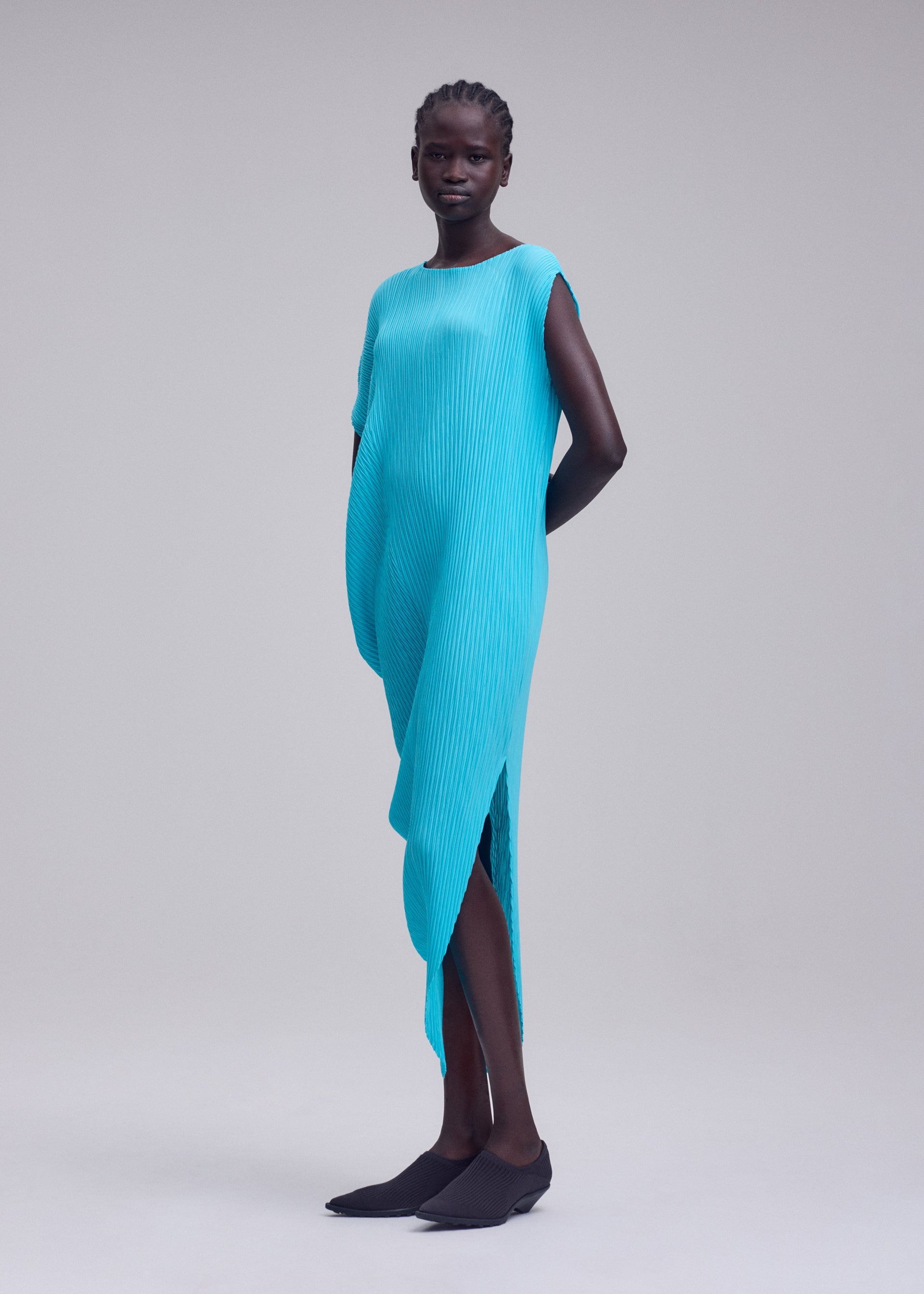 A model wears the ISSEY MIYAKE LEAF PLEATS leaf-pleats-dress-off-white.