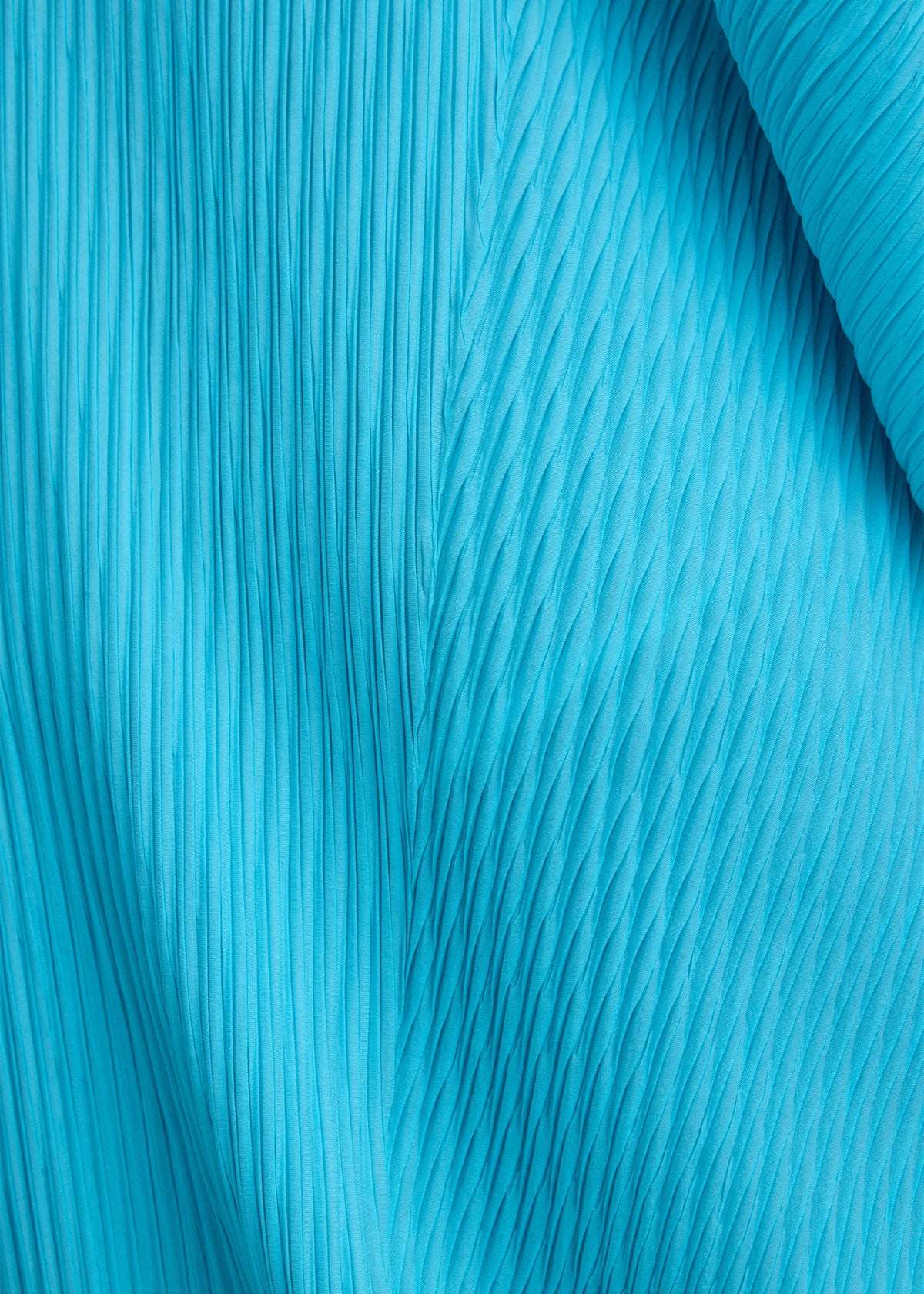A model wears the ISSEY MIYAKE LEAF PLEATS leaf-pleats-dress-dark-navy.